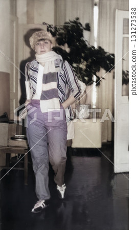 Vintage portrait of a young attractive woman dressed as Great Schemer Ostap Bender at a New Year's party. Retro photo, 1986. 131273588