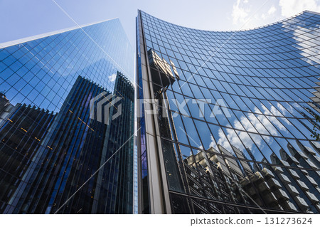 Low angle view of reflective office towers and city skyline, contemporary design Low angle view of reflective office towers and city skyline, contemporary design 131273624