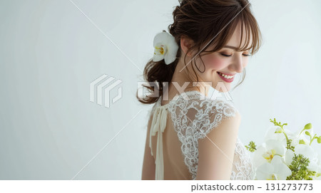 wedding, bride, veil, Elegant woman with long hair, wearing a delicate lace dress, smiles gently while holding a bouquet of white flowers, showcasing beauty and grace in a serene setting 131273773