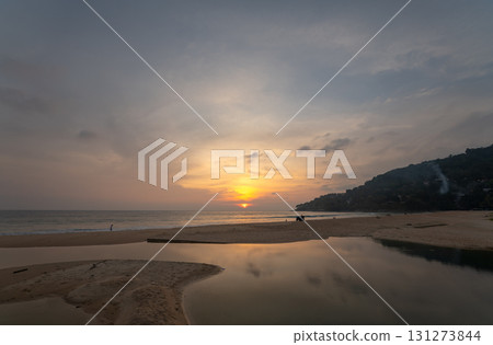 sweet sky at sunset reflection in the beach puddle. sweet sky at sunset reflection in the beach puddle. 131273844