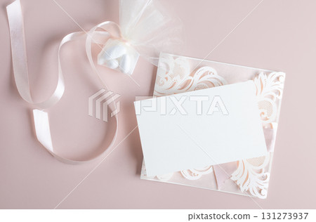 White wedding luxury invitation card mockup 7x5 on pastel pink background with envelop and flavor White wedding luxury invitation card mockup 7x5 on pastel pink background with envelop and flavor 131273937