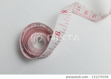 A measuring tape is displayed on a white 131274356