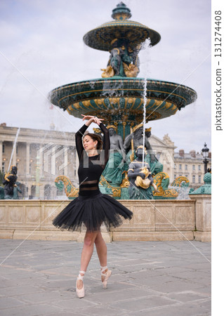 Ballet dancer performing near fountain in Paris Ballet dancer performing near fountain in Paris 131274408