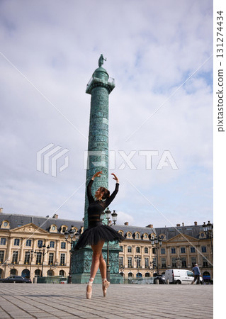 Ballet dancer jumping in city square Paris 131274434