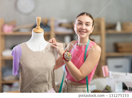 Tailor connects parts of dress on mannequin Tailor connects parts of dress on mannequin 131275153