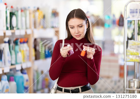 Woman choosing nail polishes 131275180