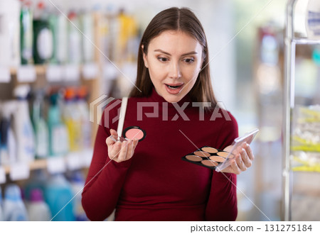 Young woman choosing blush and sculptor in store Young woman choosing blush and sculptor in store 131275184