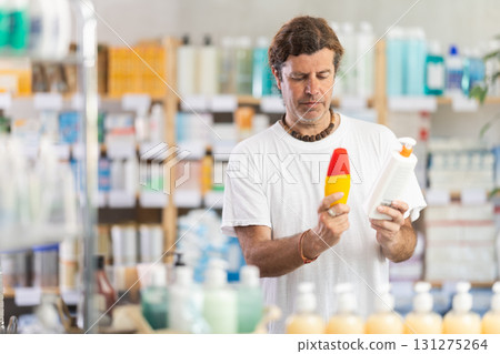 man chooses sunscreen 131275264