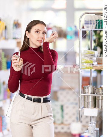 Young woman choosing perfume 131275368