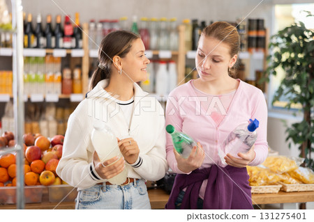 Young women choosing soda in grocery store Young women choosing soda in grocery store 131275401