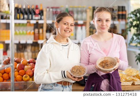 Young women choosing yakisoba in grocery store Young women choosing yakisoba in grocery store 131275418