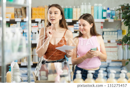 Woman with daughter choosing prescription drugs Woman with daughter choosing prescription drugs 131275457