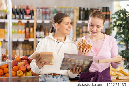 Young women choosing sweets in grocery store Young women choosing sweets in grocery store 131275485