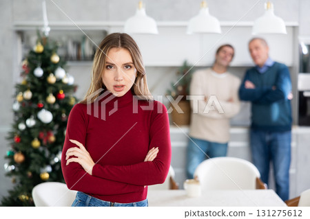 Family quarrel at Christmas - sad woman does not want to talk to father and husband 131275612