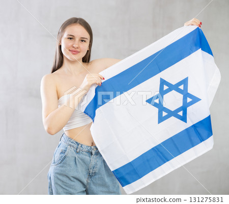 Young woman with Israel flag posing in studio Young woman with Israel flag posing in studio 131275831