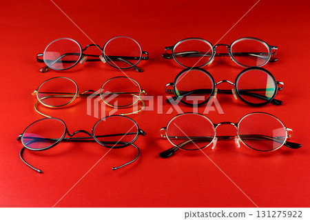 Selection of Old Fashioned Spectacle Frames on a Red Background 131275922