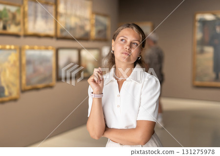 Woman view pictures and icons in museum hall 131275978
