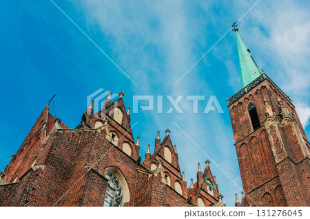 intricate facade of a Gothic church is set against a bright blue sky, wroclaw, Poland intricate facade of a Gothic church is set against a bright blue sky, wroclaw, Poland 131276045