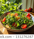 Experience freshness with this vibrant arugula and cherry tomato salad under warm sunlight 131276287