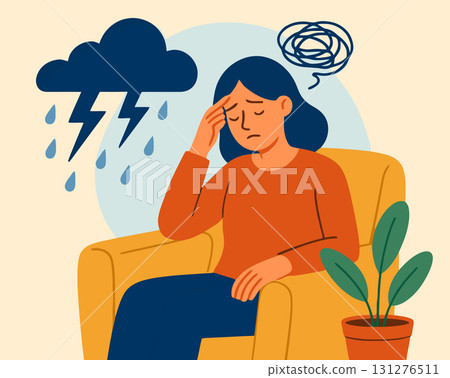 Woman feeling sad sitting in chair with hand on forehead Woman feeling sad sitting in chair with hand on forehead 131276511