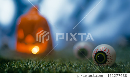 Horror eye with halloween pumpkin in the background Horror eye with halloween pumpkin in the background 131277688