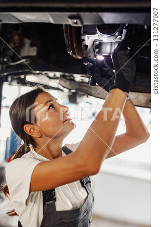 A Highly Skilled Mechanic Engaged in Working on an Automobile Vehicle for Maintenance A Highly Skilled Mechanic Engaged in Working on an Automobile Vehicle for Maintenance 131277907