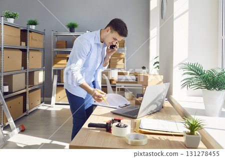 Young business man phone talk, laptop working online, checking box item title, price 131278455