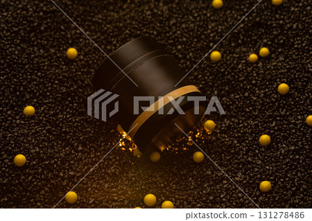 stylish black container sits among scattered yellow beads on a dark textured surface. The design highlights simplicity and elegance perfect for showcasing cosmetics. 131278486