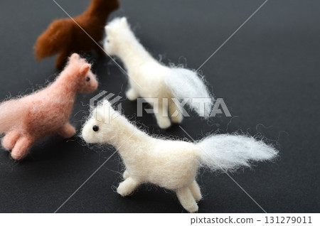 Wool felt horse on a black background 131279011