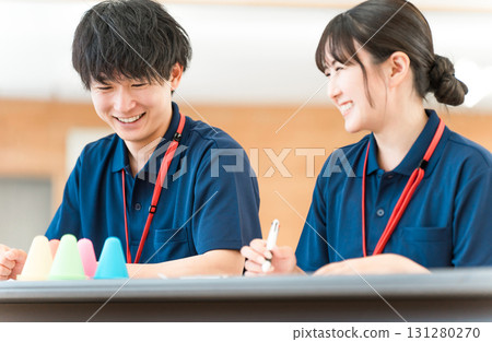 Male and female care workers and care managers receiving training (study group, meeting) 131280270