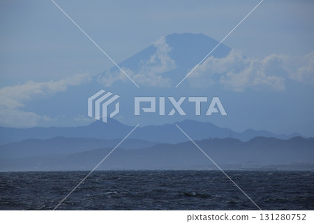 Mount Fuji floating above the clouds seen from the sea 131280752