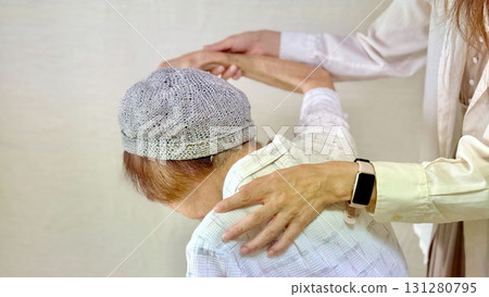 Woman raising the arm of an elderly woman Woman raising the arm of an elderly woman 131280795