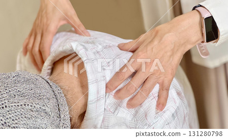 A woman's hands massaging the shoulders of an elderly woman 131280798