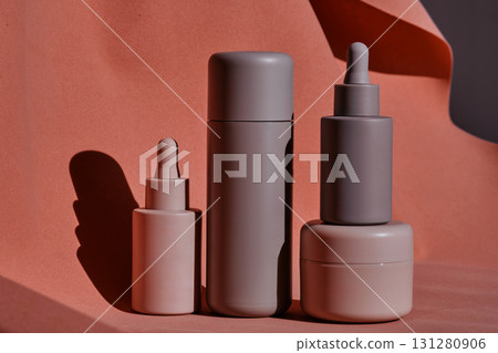 A set of cosmetics for face and body on a terracotta background. 131280906