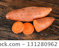 Sweet potato with slices isolated on wooden background 131280962