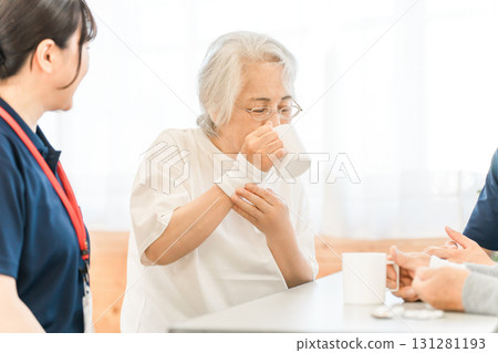 Senior woman and female occupational therapist doing swallowing training at a nursing home or care facility 131281193
