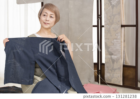 Senior woman caring for and arranging her kimono 131281238