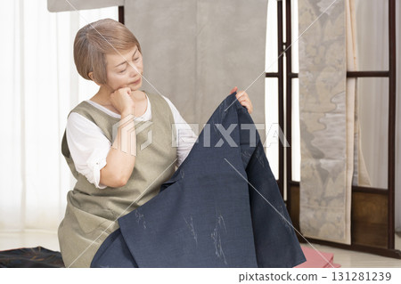 Senior woman caring for and arranging her kimono 131281239