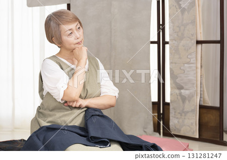 Senior woman caring for and arranging her kimono Senior woman caring for and arranging her kimono 131281247