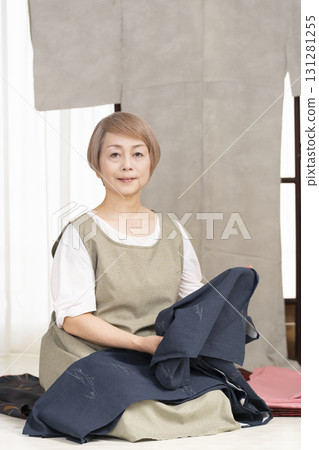 Senior woman caring for and arranging her kimono 131281255