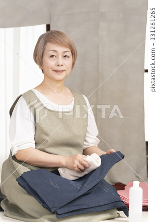 Senior woman caring for and arranging her kimono 131281265