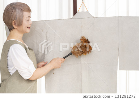Senior woman caring for and arranging her kimono Senior woman caring for and arranging her kimono 131281272