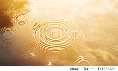 raindrop circles forming ripples on water golden sunlight raindrop circles forming ripples on water golden sunlight 131282582