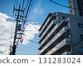 晴朗天空下，公寓大樓和電線桿被陽光照亮 131283024