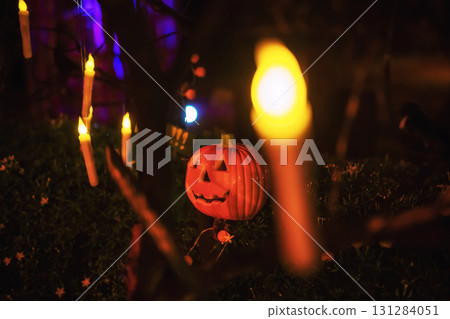 Pumpkin lantern and hanging candles light up in park. Halloween 131284051