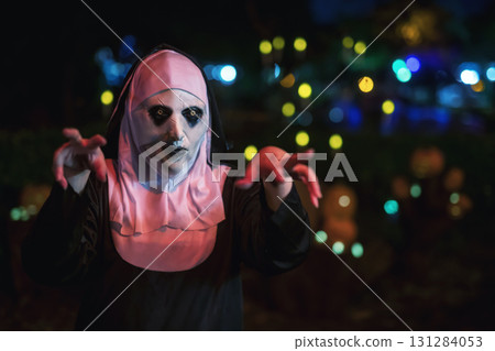 Scary woman in devilish nun mask and dress with fear hand gesture Scary woman in devilish nun mask and dress with fear hand gesture 131284053
