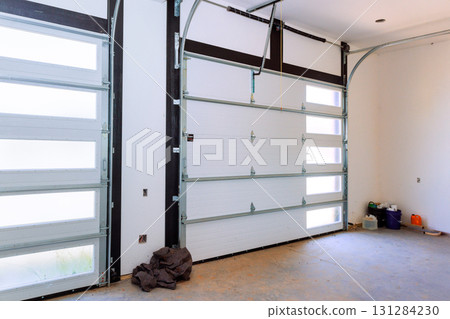 Clean garage space features large windows, allowing sunlight to brighten area. 131284230
