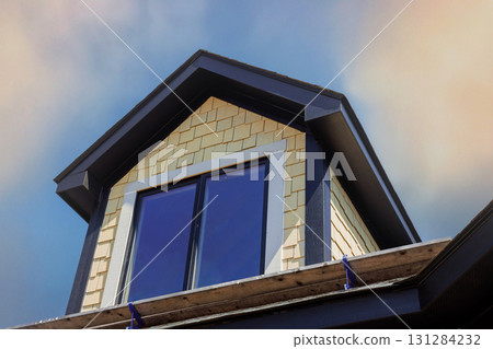 Roof features large windows set in charming design, craftsmanship build new house Roof features large windows set in charming design, craftsmanship build new house 131284232