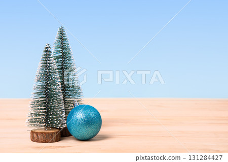 Christmas background with green tree and turquoise Christmas balls on a wooden table. Christmas and New Year design holiday card 131284427