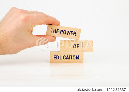 Business and Words Matter concept. Copy space. THE POWER OF EDUCATION made from blocks with hand on white background 131284887